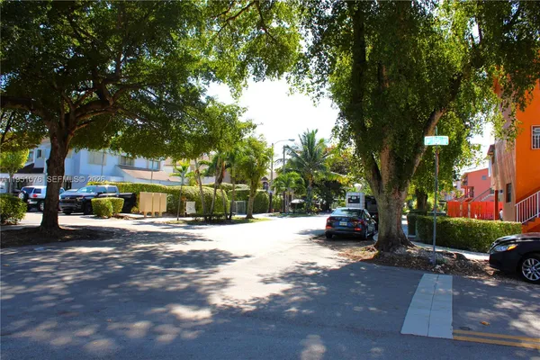 a view of street with parked cars