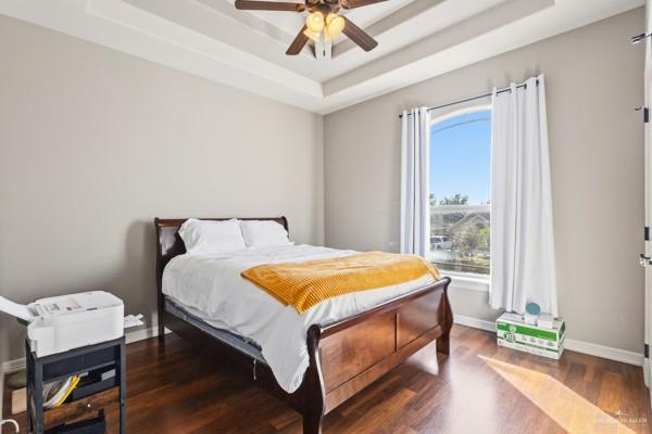 1405 Eva Street Edinburg, TX 78539 - Photo 13 of 18 a bedroom with a bed and a chandelier