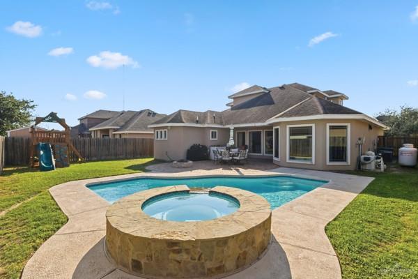 1405 Eva Street Edinburg, TX 78539 - Photo 18 of 18 a view of a house with swimming pool and a yard