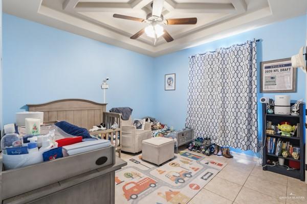 1405 Eva Street Edinburg, TX 78539 - Photo 8 of 18 a bedroom with a bed and a chandelier