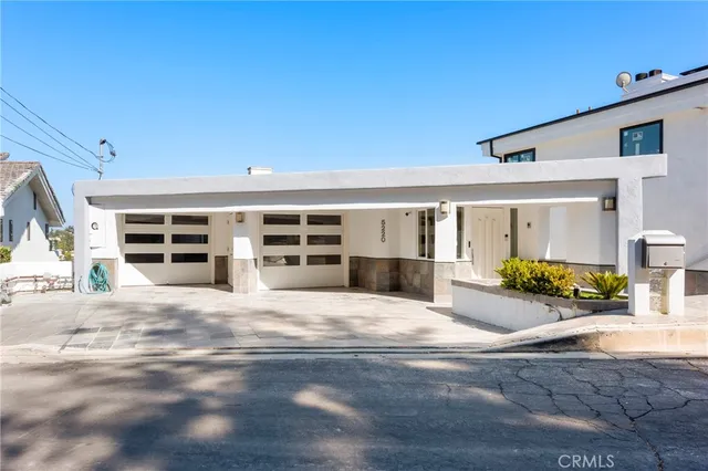 an empty room with ceiling fan and windows