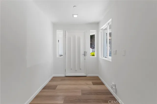 a view of a workspace with furniture and wooden floor