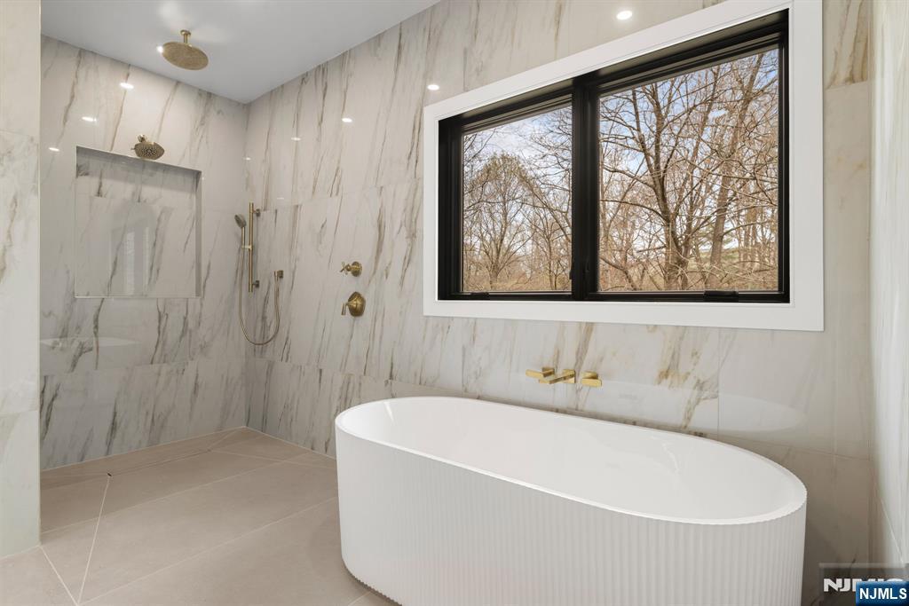 45 Riverview Terrace Mahwah, NJ 07430 - Photo 11 of 25 a white bath tub sitting next to a shower