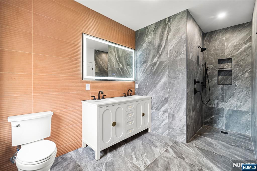 45 Riverview Terrace Mahwah, NJ 07430 - Photo 17 of 25 a bathroom with a sink a toilet and shower