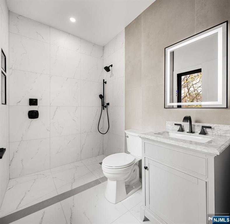 45 Riverview Terrace Mahwah, NJ 07430 - Photo 21 of 25 a bathroom with a granite countertop sink a toilet and shower