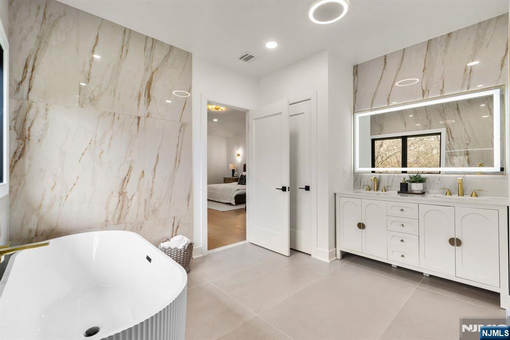 45 Riverview Terrace Mahwah, NJ 07430 - Photo 10 of 25 a bathroom with a tub sink and mirror