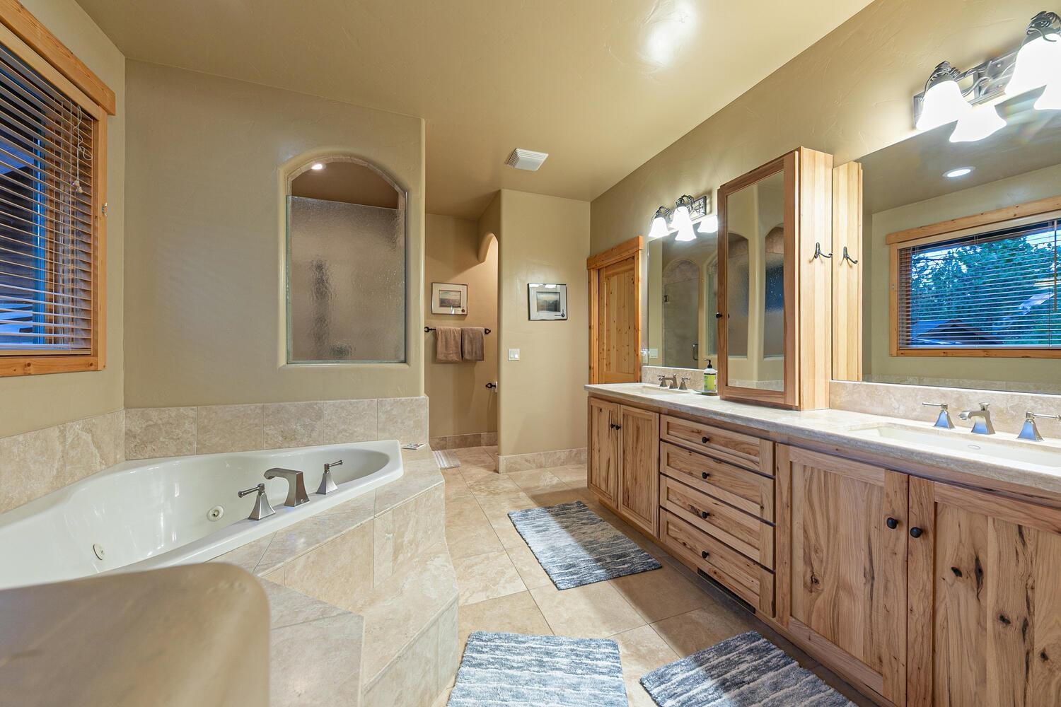 14070 Alder Creek Road Truckee, CA 96161 - Photo 11 of 28 a large bathroom with a tub sink shower and mirror