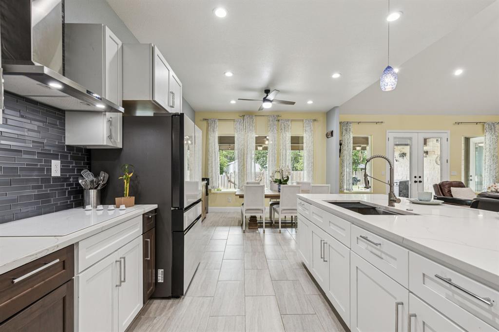 6467 Asher Road Alvarado, TX 76009 - Photo 15 of 40 a large kitchen with stainless steel appliances kitchen island granite countertop a large counter top a stove and a sink