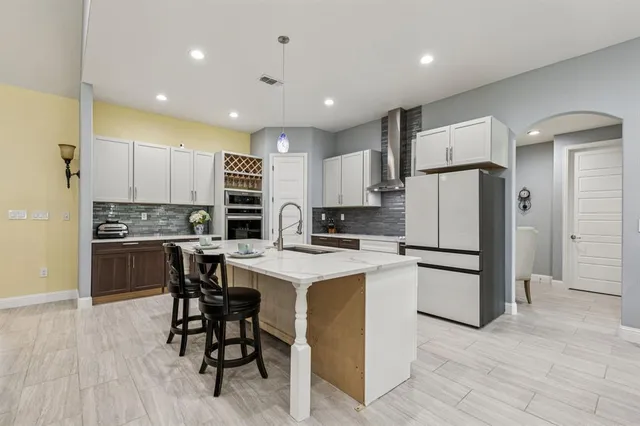 a kitchen with a refrigerator a counter top space and cabinets
