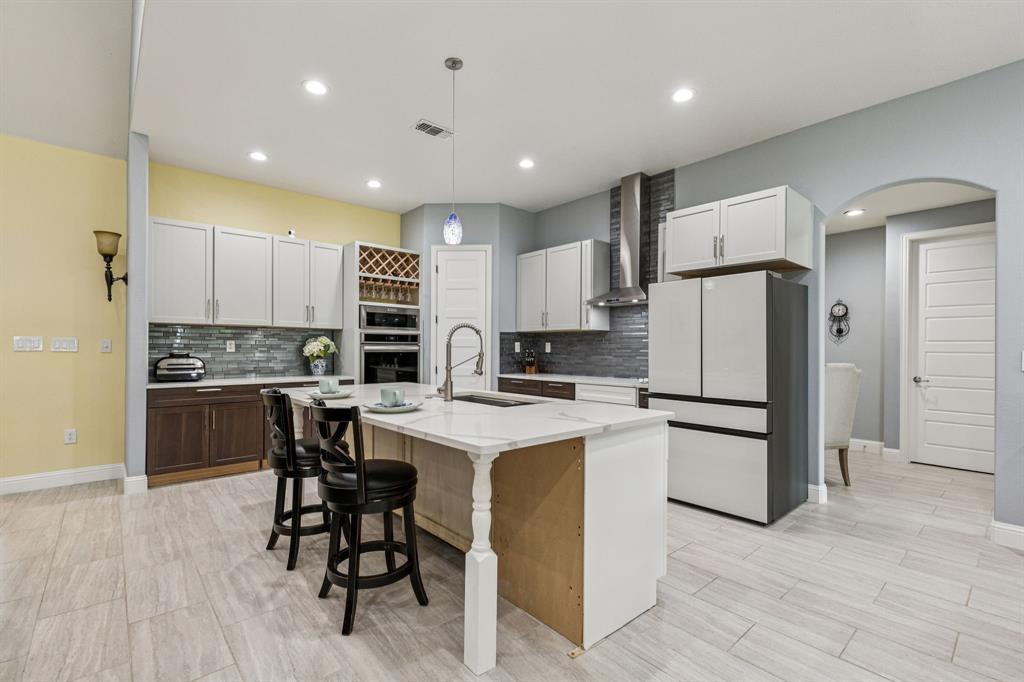 6467 Asher Road Alvarado, TX 76009 - Photo 17 of 40 a kitchen with a refrigerator a counter top space and cabinets