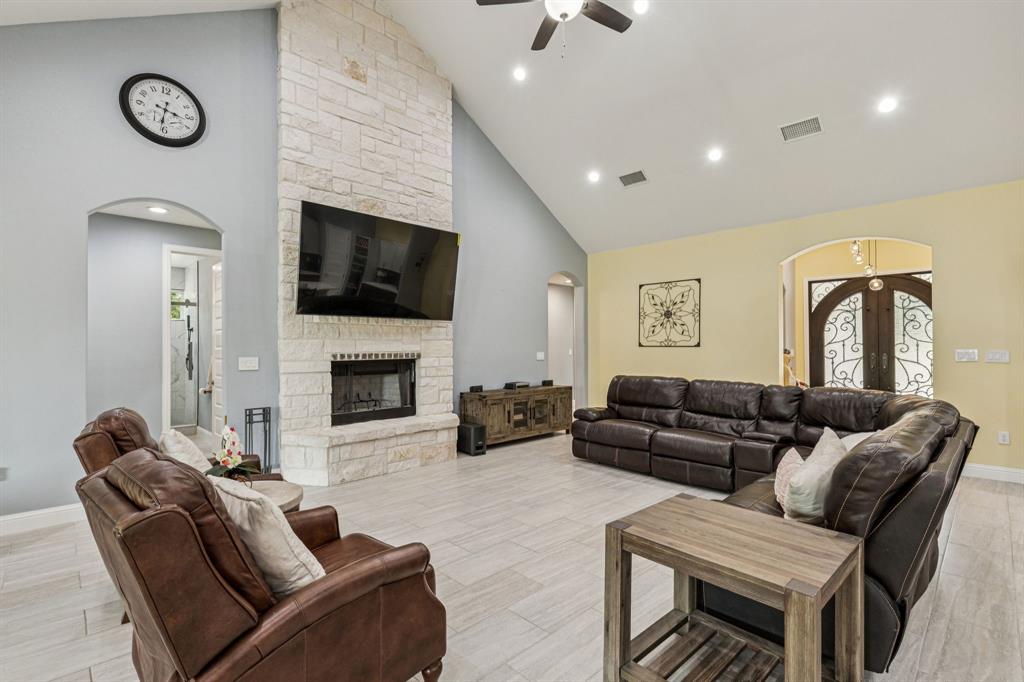 6467 Asher Road Alvarado, TX 76009 - Photo 20 of 40 a living room with furniture a flat screen tv and a fireplace