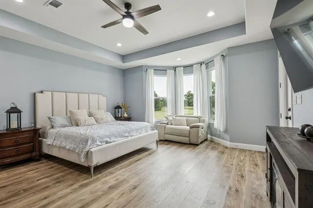 a bedroom with a bed and a large window