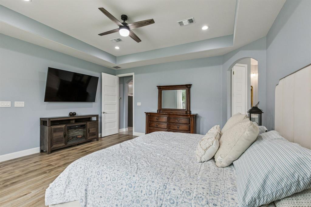 6467 Asher Road Alvarado, TX 76009 - Photo 25 of 40 a bedroom with a bed and a flat screen tv