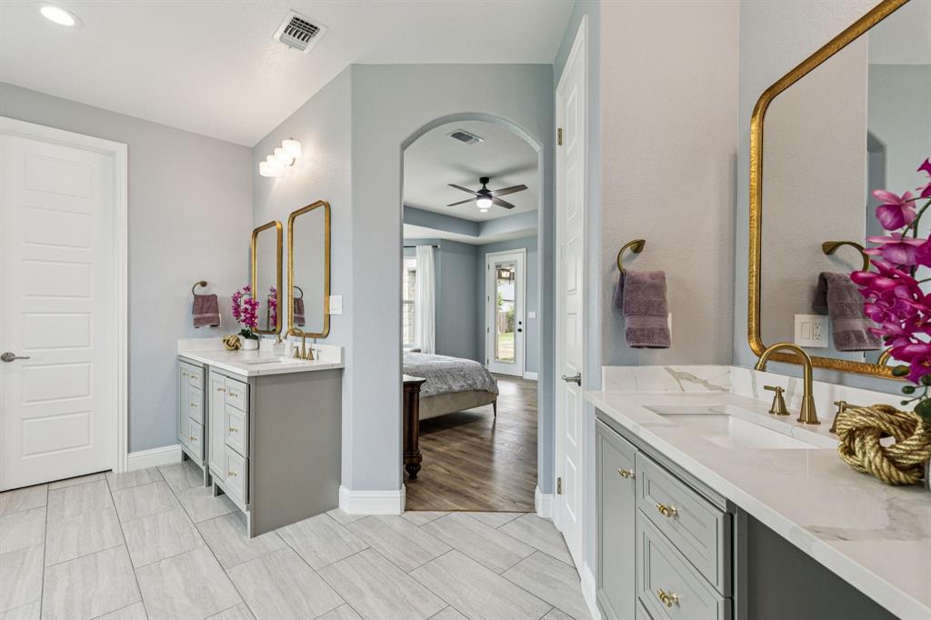 6467 Asher Road Alvarado, TX 76009 - Photo 28 of 40 a spacious bathroom with a sink double vanity and a mirror
