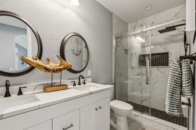 a bathroom with a toilet a sink and a mirror