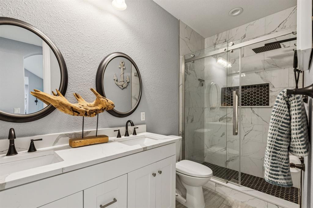 6467 Asher Road Alvarado, TX 76009 - Photo 30 of 40 a bathroom with a toilet a sink and a mirror