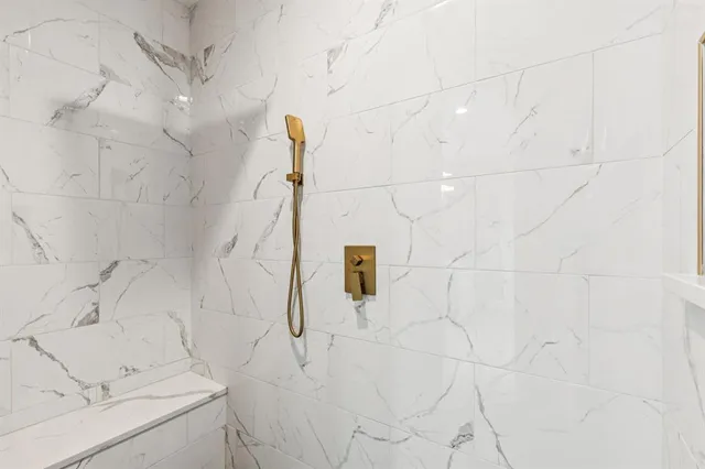 a bathroom with a shower and a shower