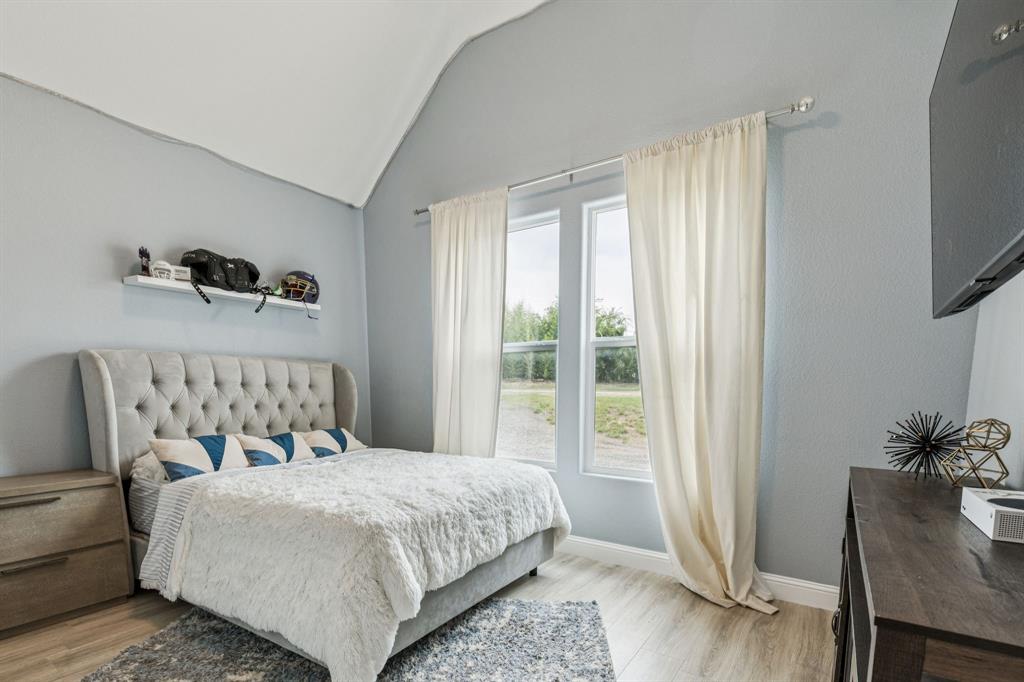 6467 Asher Road Alvarado, TX 76009 - Photo 33 of 40 a bedroom with a bed and a chair