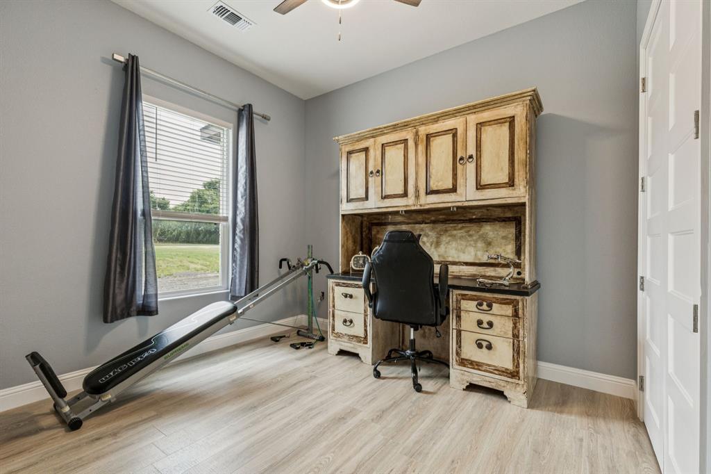 6467 Asher Road Alvarado, TX 76009 - Photo 36 of 40 a view of workspace with wooden floor windows gym equipment and windows