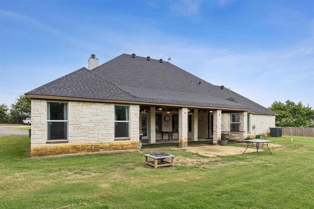 6467 Asher Road Alvarado, TX 76009 - Photo 39 of 40 a backyard of a house with yard table and chairs