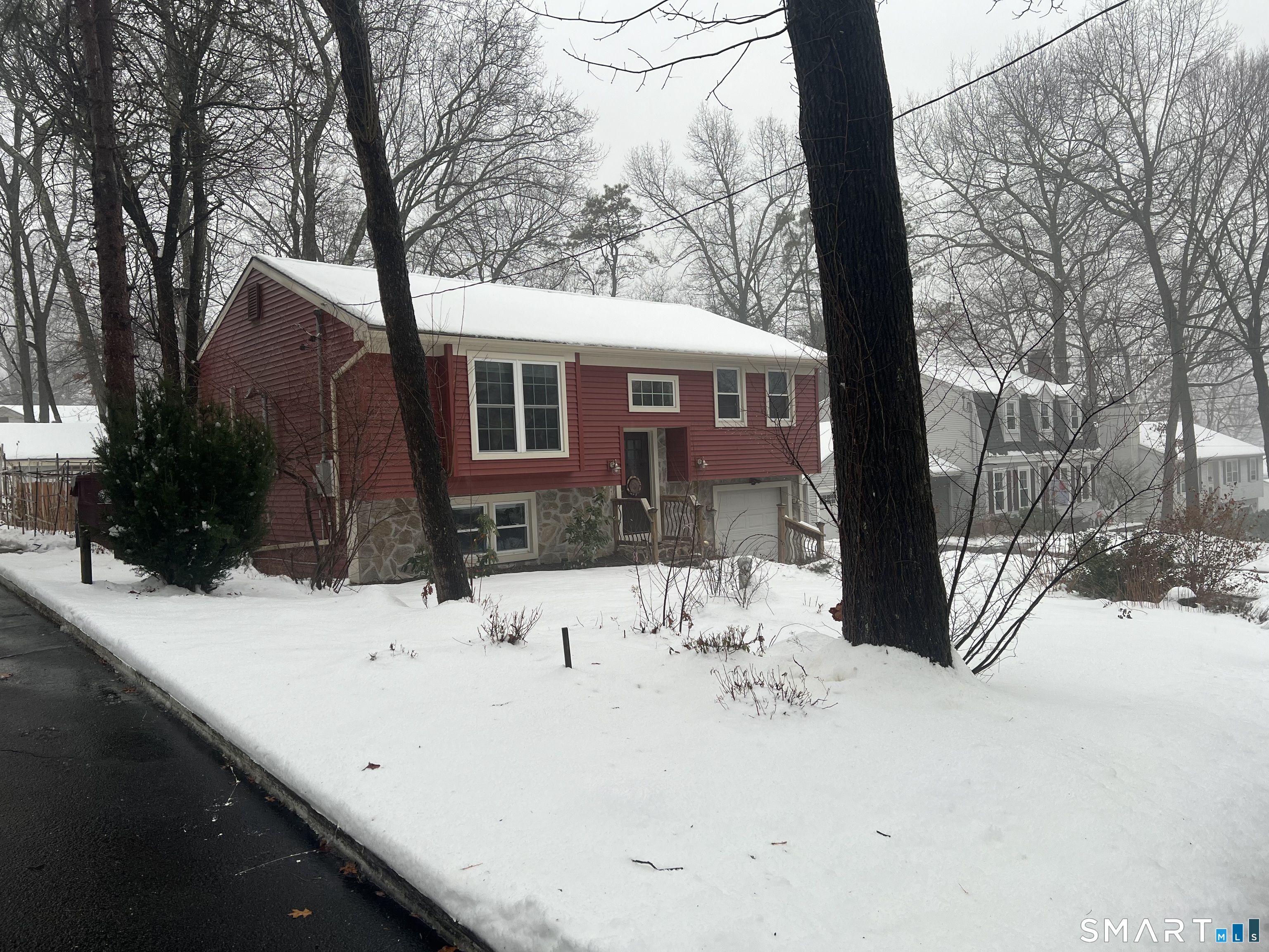 a view of a house with snow in the backyard
