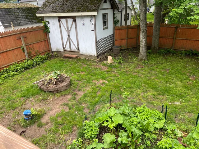 a view of a backyard with sitting area
