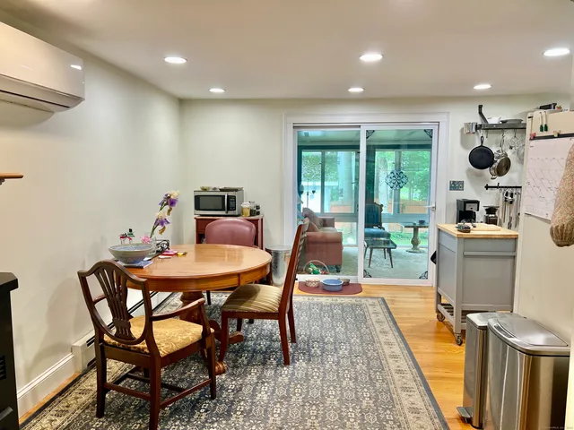 a dining room with furniture and a floor to ceiling window