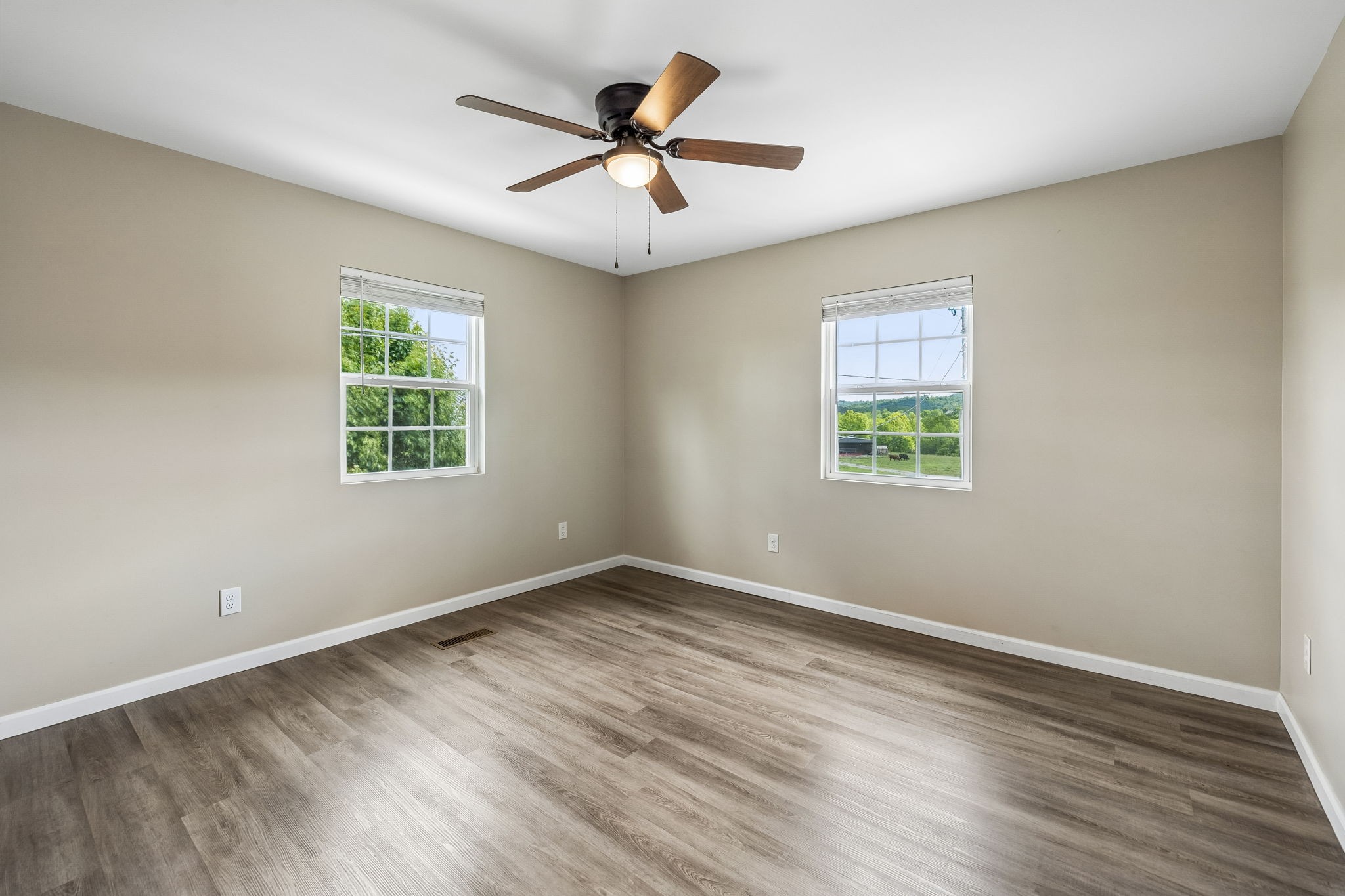 124 Hickman Creek Road South Hickman, TN 38567 - Photo 18 of 45 an empty room with wooden floor and windows