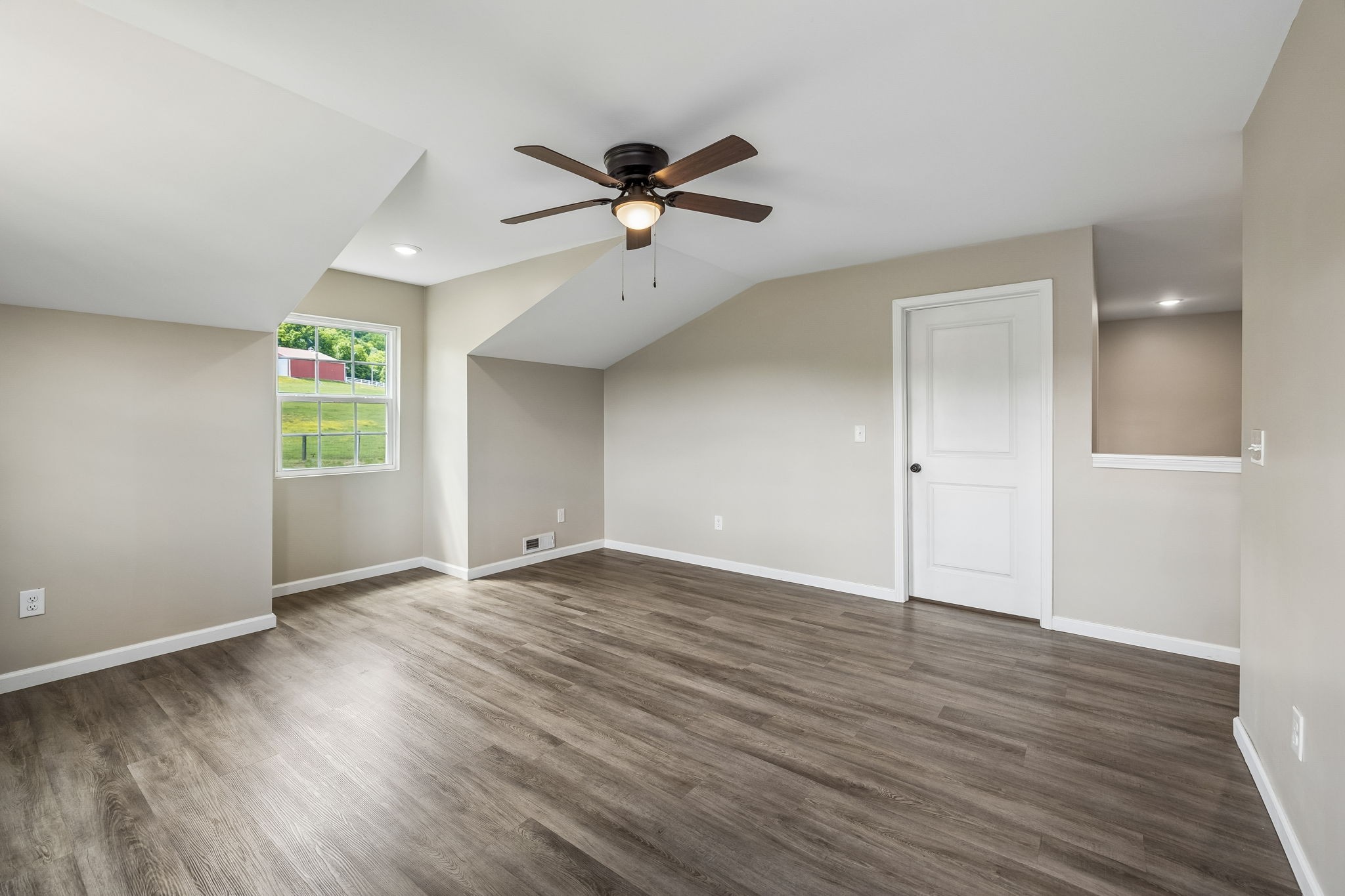 124 Hickman Creek Road South Hickman, TN 38567 - Photo 23 of 45 an empty room with wooden floor chandelier fan and windows