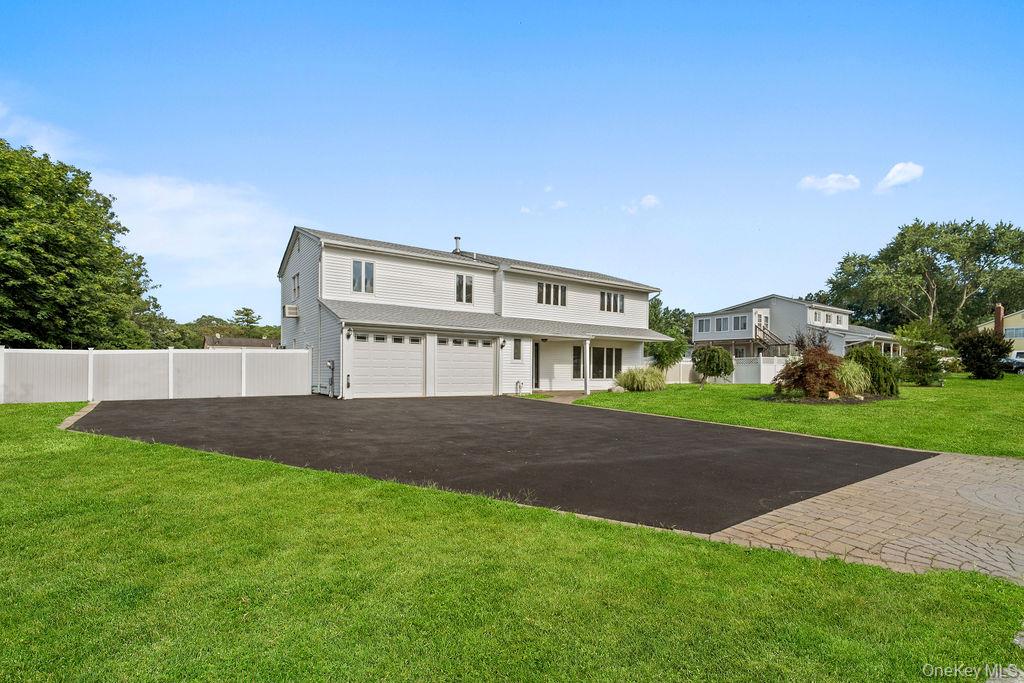 35 Thomas Street Coram, NY 11727 - Photo 1 of 1 View of front of property with asphalt driveway and an attached garage