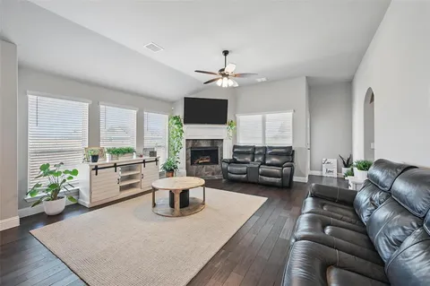 a living room with furniture fireplace and a flat screen tv
