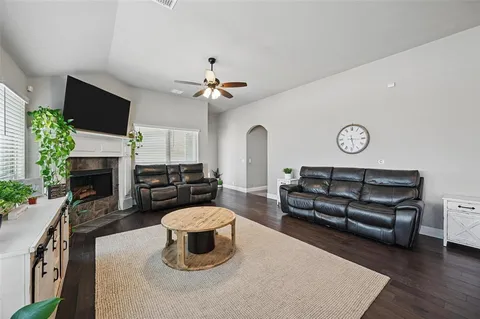 a living room with furniture a fireplace and a flat screen tv