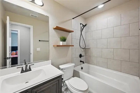 a bathroom with a sink a toilet and a mirror