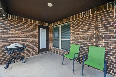 a front view of a house with outdoor seating