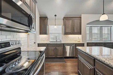 a kitchen with stainless steel appliances granite countertop a stove and a sink