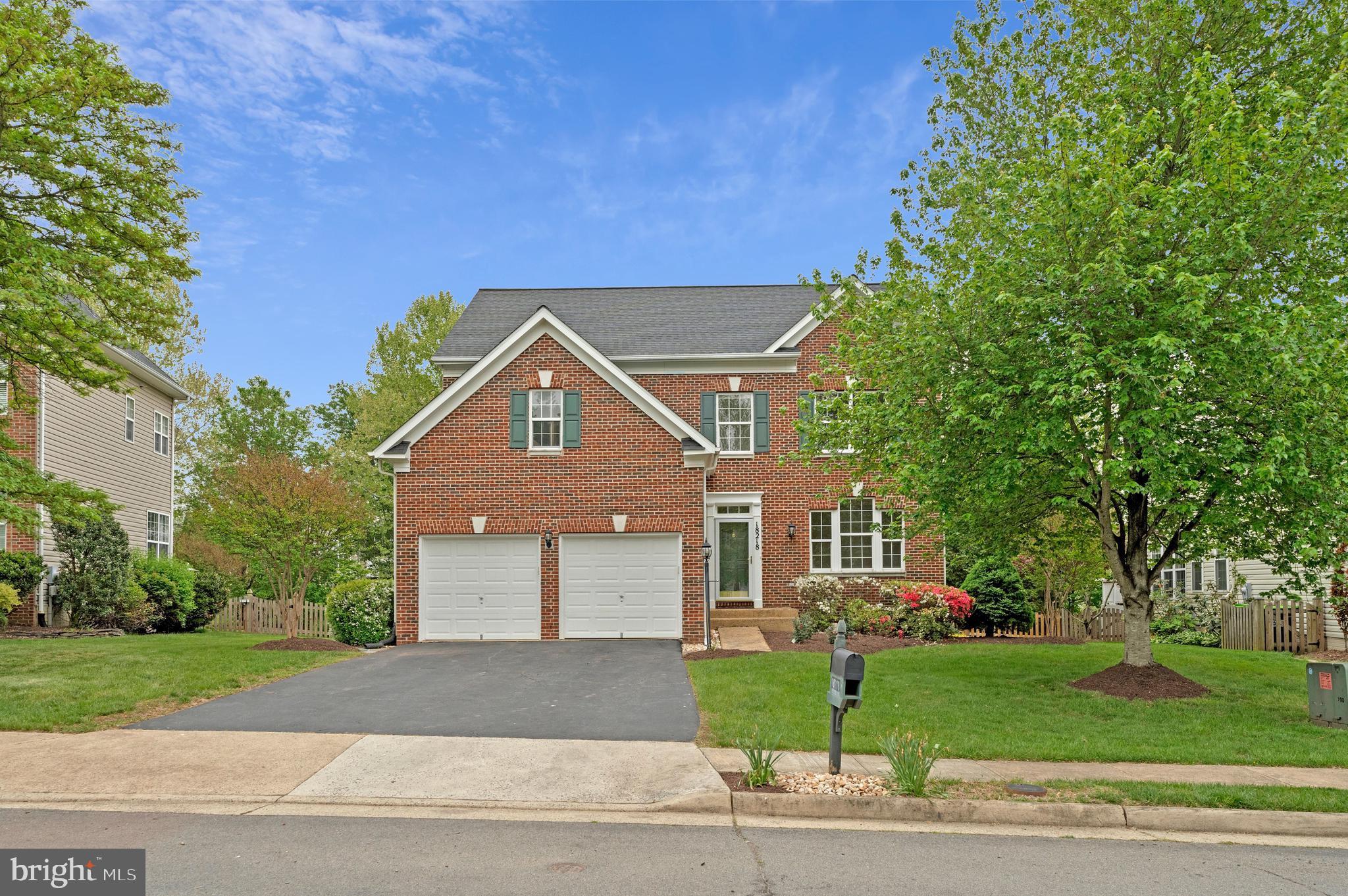 18218 Red Rock Way Leesburg, VA 20176 - Photo 1 of 49 Charming brick home with lush greenery.
