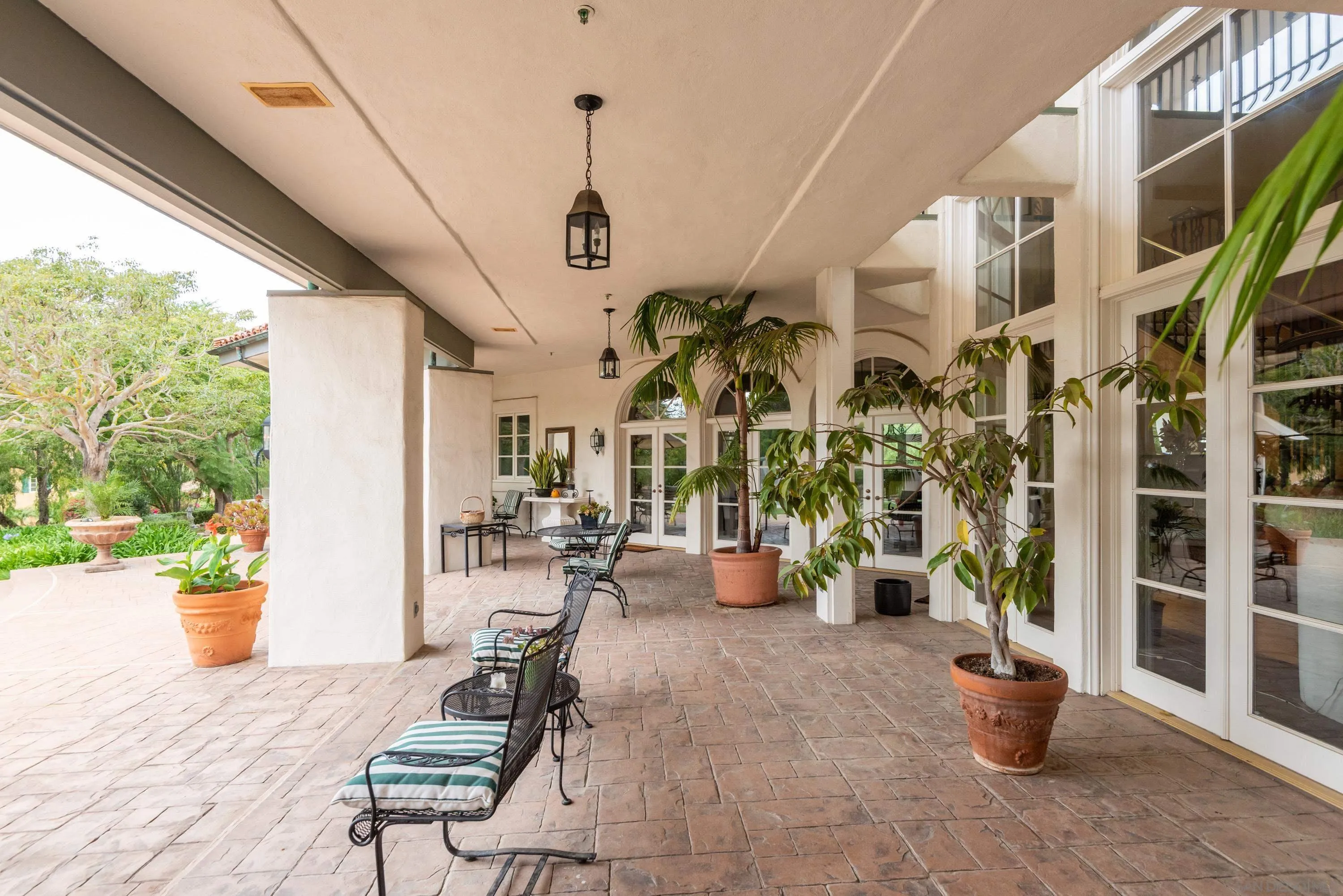18279 Via De Sueno Rancho Santa Fe, CA 92091 - Photo 33 of 53 a view of a porch with chairs and potted plants