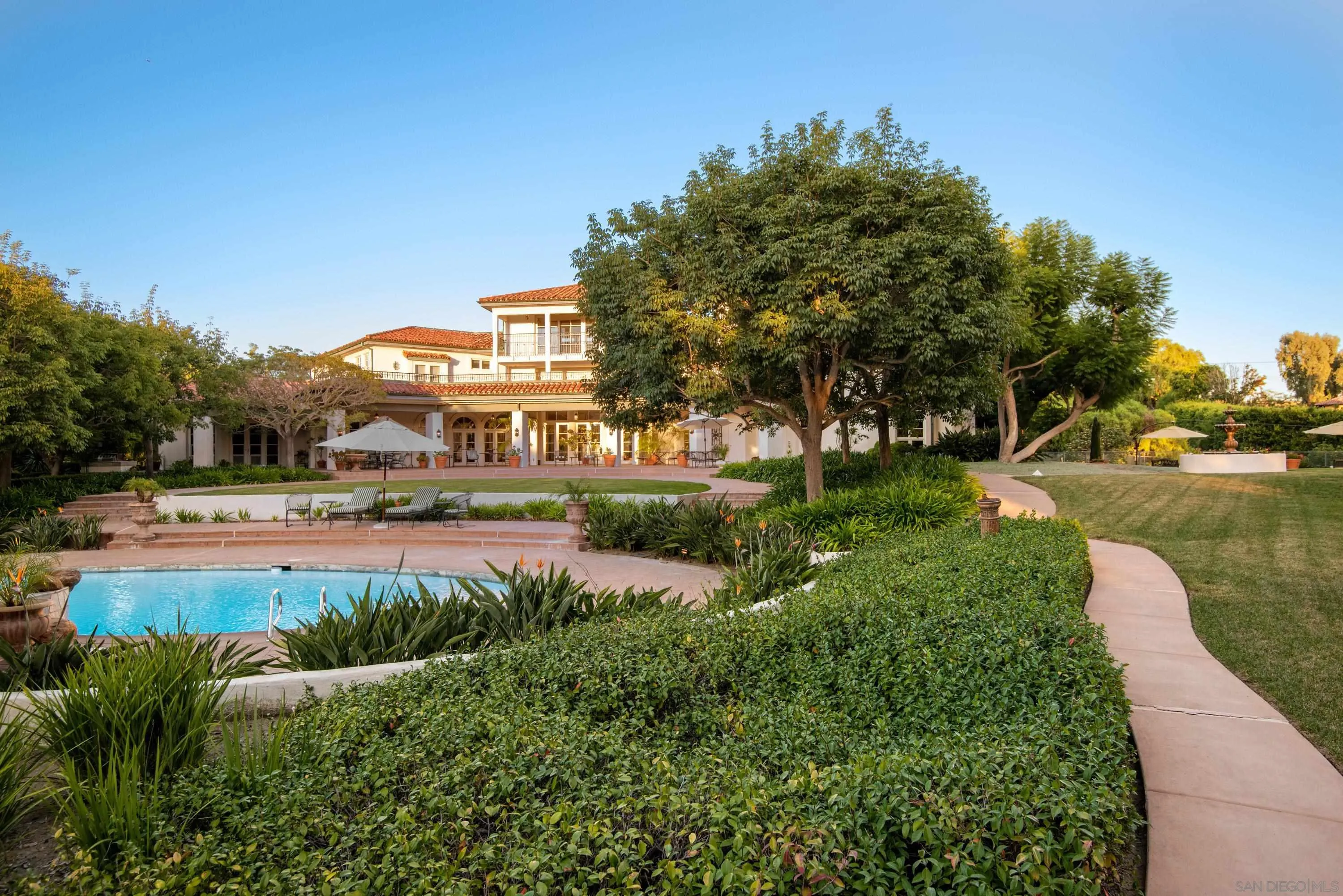 18279 Via De Sueno Rancho Santa Fe, CA 92091 - Photo 34 of 53 a view of a lake with a house in the background