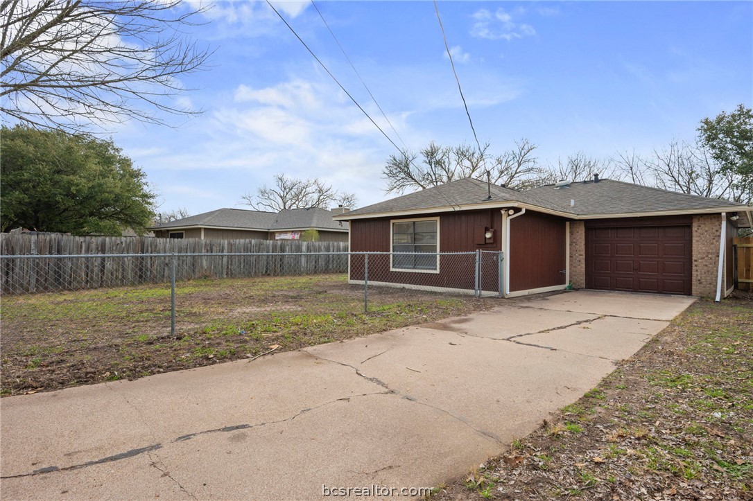 4752 Brompton Lane Bryan, TX 77802 - Photo 13 of 17 Back of home view of garage and yard