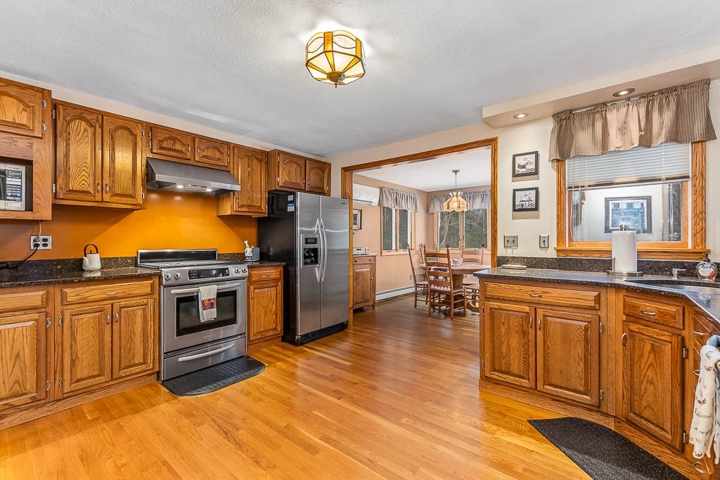 70 Deerfield Road Sharon, MA 02067 - Photo 2 of 29 a kitchen with stainless steel appliances granite countertop a stove a sink dishwasher and a refrigerator