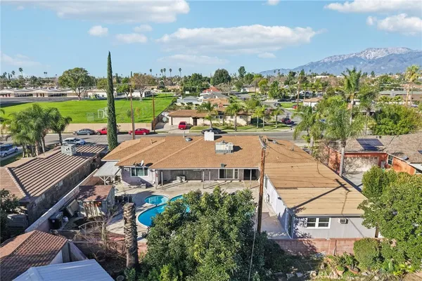 an aerial view of a house with a yard lake view and mountain view