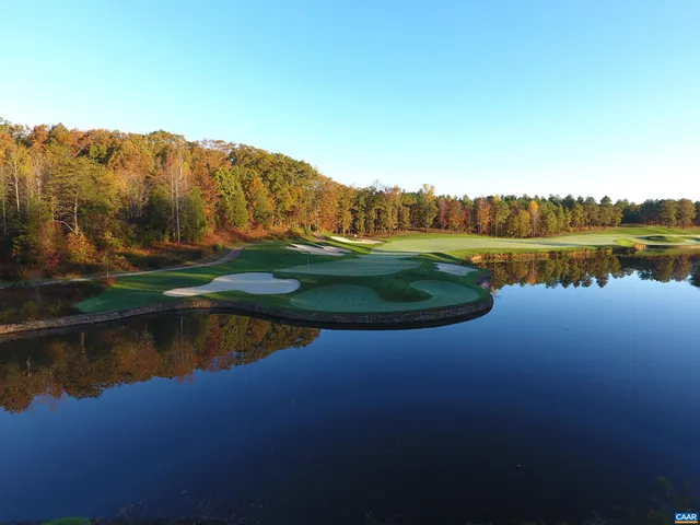 an aerial view of a houses with outdoor space and lake view
