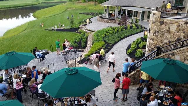 an aerial view of a house with garden space and lake view