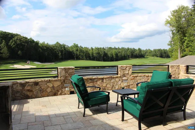 a view of a patio with a table chairs and a backyard