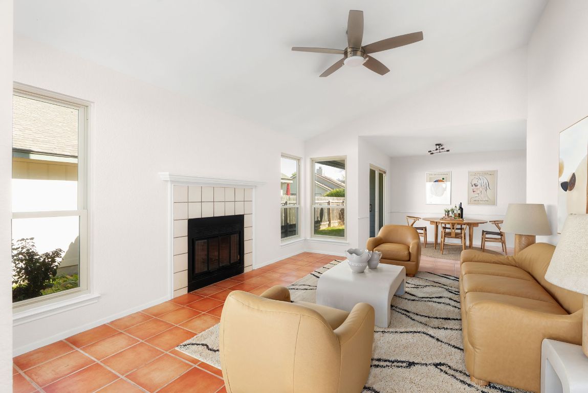a living room with furniture fireplace and a window
