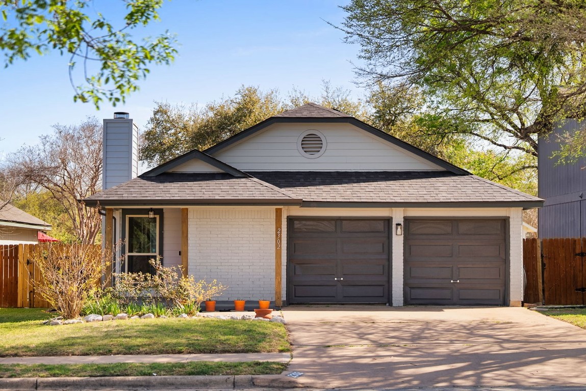 2302 Dowd Lane Austin, TX 78728 - Photo 1 of 23 a front view of a house with garden