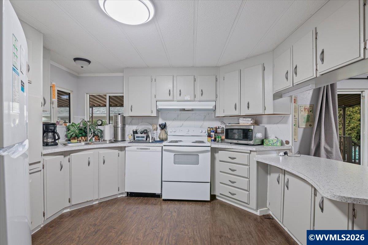 5422 Portland Road Northeast, Unit 123 Salem, OR 97305 - Photo 11 of 23 a kitchen with white cabinets and white appliances
