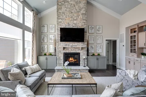a living room with furniture kitchen view and a large window