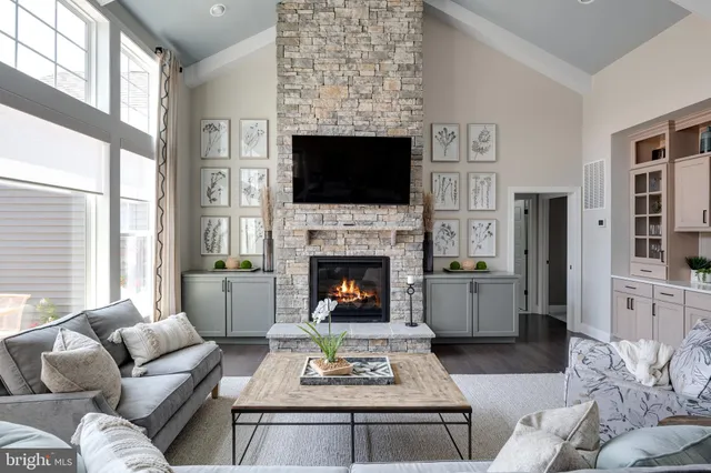 a living room with furniture kitchen view and a large window