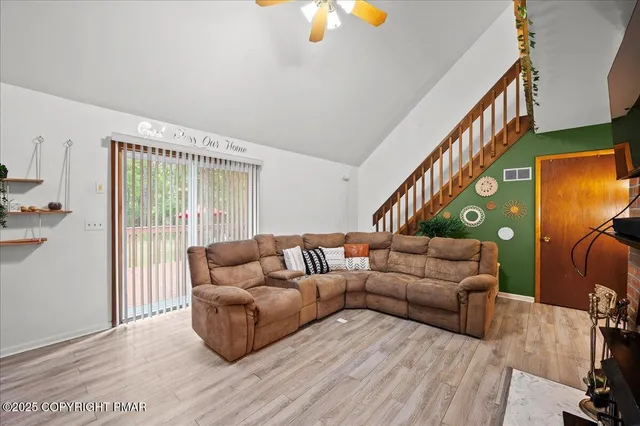 a living room with furniture and a lamp